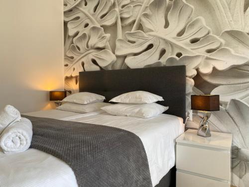 a bedroom with a large bed with a wooden headboard at Pokoje Gościnne Akwatel in Jastarnia