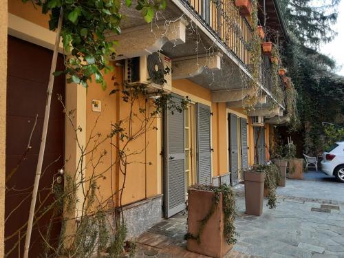 a row of houses with yellow walls and balconies at Corte Delle Rose in Voghera