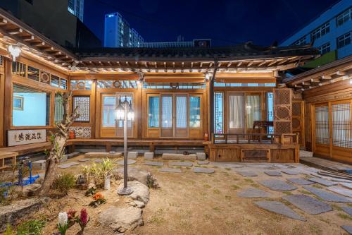 a house with a courtyard in front of it at Aega Hanok Guesthouse in Daegu