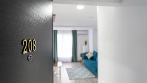 a door to a living room with a blue couch at Sea View Apartments Olimp - Avenue Hotels in Olimp
