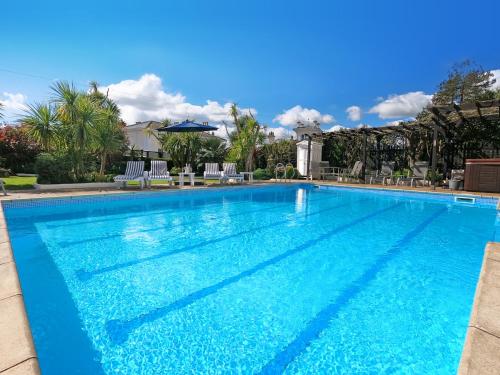 a large swimming pool with blue water at Riviera Lodge Hotel in Torquay