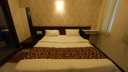 a bedroom with a large bed in a room at Silver Suite in Chikmagalūr