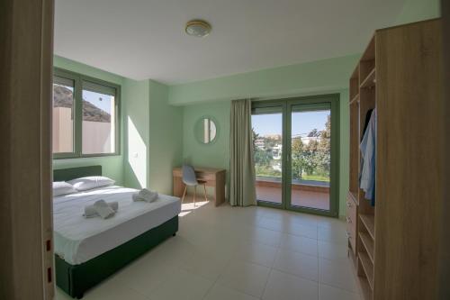 a bedroom with a bed and a large window at Eden Lily- Luxurious Apartment with Sea View in Rhodes Town