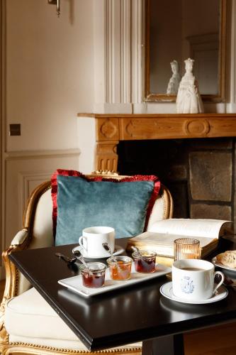 a table with two cups of tea on top of it at Château de Saint Vidal in Le Puy en Velay