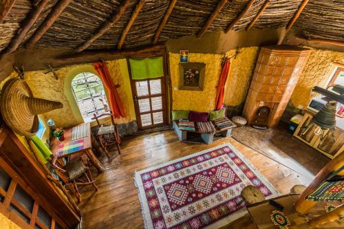 an overhead view of a living room with a rug at Viewtopia The Secret Land in Valea Drăganului