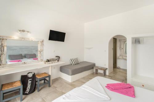 a bedroom with a bed and a mirror at Irini Rooms in Naousa