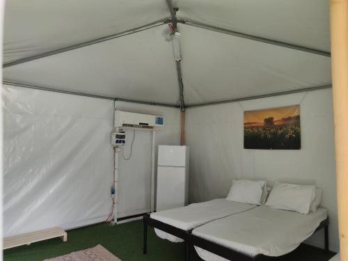 a room with a bed in a tent at The Camping Site Hamat Gader in Kinneret
