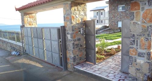 an entrance to a house with metal gates at Dimitris Vaso’s Villa with Sea and Mountain View! in Aliveri