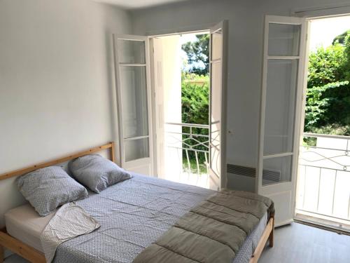 une chambre avec un lit et une grande fenêtre dans l'établissement Cannes center parking very calm California neighborhood, à Cannes