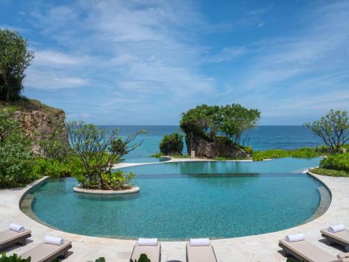 an infinity pool with the ocean in the background at Jumeirah Bali in Uluwatu