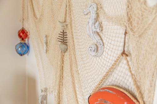 a white sweater with embroideredidered items on it at Ca Minorica -Apartamento- in Son Parc