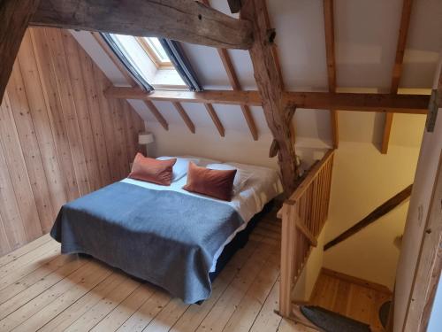 a bedroom with a bed in a attic at Erfgoed & Logies Den Heijkant in Moergestel