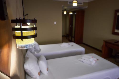 Katil atau katil-katil dalam bilik di HOTEL ADRIANO
