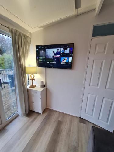 a living room with a flat screen tv on the wall at 147 Snowdon Drive, Glan Gwna in Caernarfon