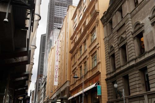 a group of buildings on a city street at The Victoria Hotel in Melbourne