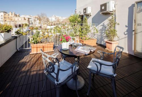 a patio with a table and chairs on a balcony at Hotel Raffaello - Sure Hotel Collection by Best Western in Rome