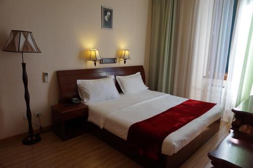 a bedroom with a bed and a lamp and a window at Hotel Filippo in Rome