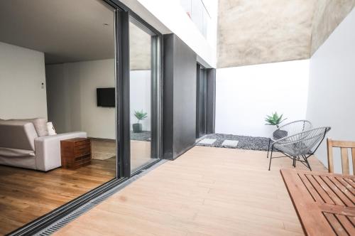 a living room with a sliding glass door at Aljube Residences I - Apt novo, com terraço, centro PDL in Ponta Delgada