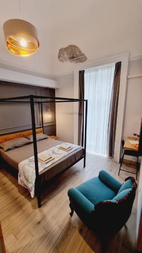 a bedroom with a bed and a chair at Cuore Mio B&b in Catania