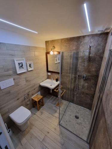 a bathroom with a shower and a toilet and a sink at Cuore Mio B&b in Catania
