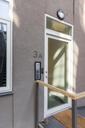 a glass door to a building with a meter at Beautiful Apartments on Strøget in Copenhagen City Center in Copenhagen
