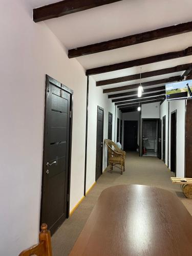 an empty hallway with a black door and a chair at Hotel Mlyn in Nikolayev