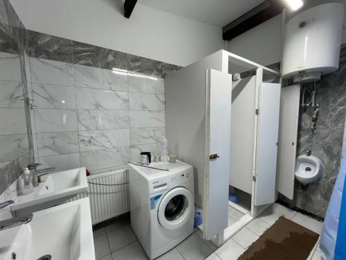 a bathroom with a washing machine and a sink at Hotel Mlyn in Nikolayev