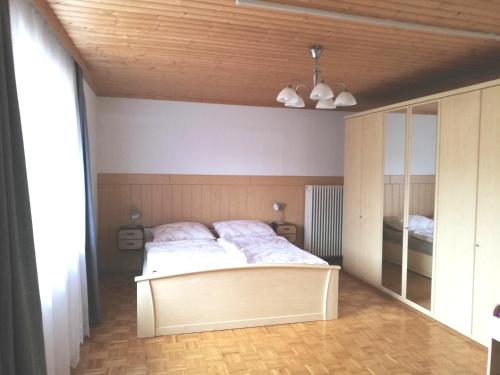 a bedroom with a bed and a large mirror at Haus Petra in Neumarkt in Steiermark