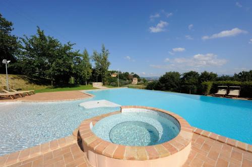 a large swimming pool with a large blue swimming pool at Agriturismo Il Vecchio Mandorlo in Perugia