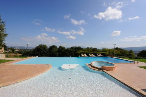 a large swimming pool with two loungers in the middle at Agriturismo Il Vecchio Mandorlo in Perugia