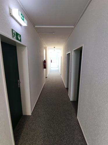 a hallway of an office building with a long corridor at Gästehaus am Bahnhof, Self-Check-In in Vechta