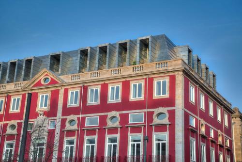 a building with a clock on the front of it at NH Collection Porto Batalha in Porto