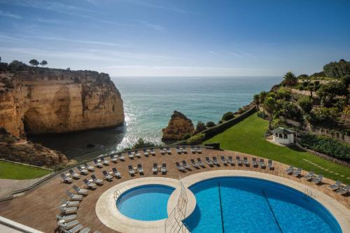 a view of the ocean from a resort with a swimming pool at Tivoli Carvoeiro in Carvoeiro