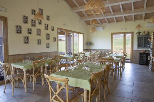 a restaurant with tables and chairs in a room at Agriturismo Casa Ricci in Magliano in Toscana