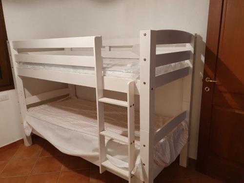 a white bunk bed in a room at Casetta Francy in San Teodoro