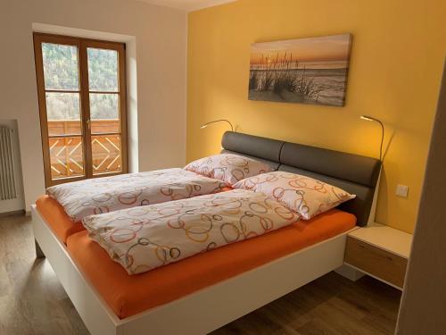 a bed with two pillows on it in a bedroom at Appartment Valentin in Chiusa