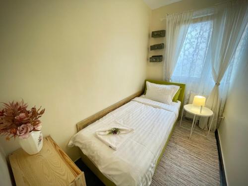 a small bedroom with a bed and a window at Perfect Place to Stay self check in-24h-NETFLIX-WIFI in Reşiţa
