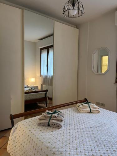 a bedroom with a bed with towels on it at Casa Willi in Fano