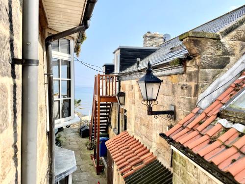 an alleyway between two buildings with a street light at Normanby Cottage Runswick Bay in Runswick