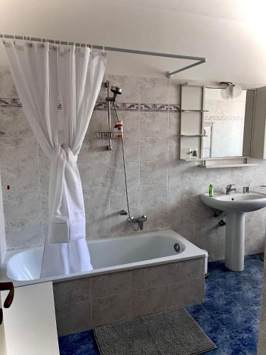 a bathroom with a bath tub and a sink at Casa Willi in Fano