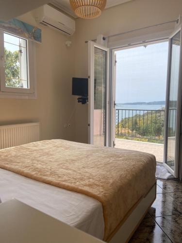 a bedroom with a large bed and a balcony at SEA VIEW DREAM in Argostoli