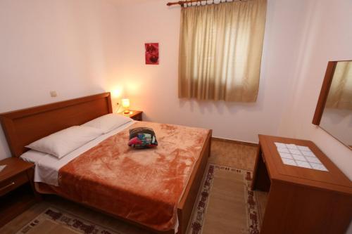 a bedroom with a bed with a backpack on it at Apartments Ana - Kustići in Novalja