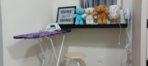 a shelf with stuffed animals and a stool on a wall at HOMESTAY ARC @ AUSTIN HILLS JB in Johor Bahru