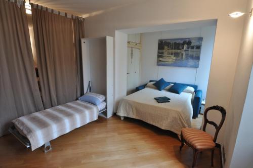 a small bedroom with a bed and a chair at La casa di Fede e Fran in Camogli