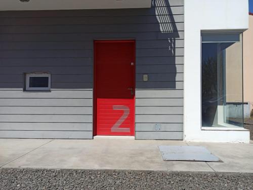 a red door with a number two on the side of a building at Lust 270 in Libertador San Martín