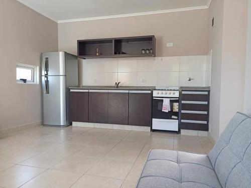 a kitchen with a refrigerator and a stove top oven at Lust 270 in Libertador San Martín
