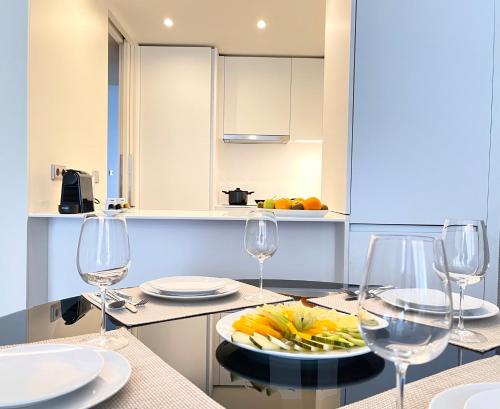 a kitchen with glasses and a plate of food on a counter at Acta The Avenue in Porto