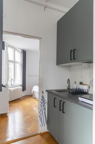 a kitchen with a counter top and a refrigerator at Hotell Villa Rönne in Ängelholm