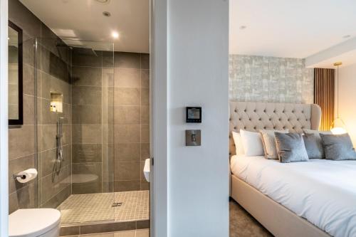 a bedroom with a bed and a shower and a toilet at Four Zero Six @ Ryedale House in York