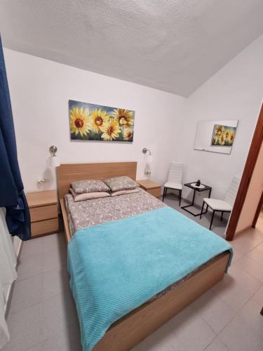 a bedroom with a bed and two chairs in it at HATO Holiday Home Fuerteventura in Costa Calma